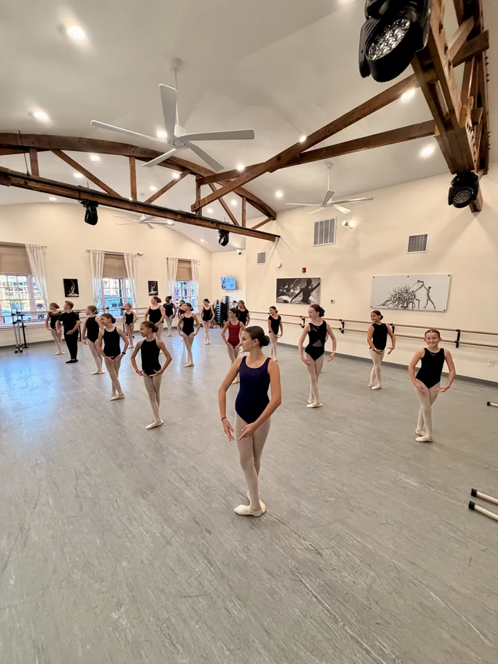 The Broadway wing of our New York City–themed space: dancers at work beneath exposed beams and our new lighting.