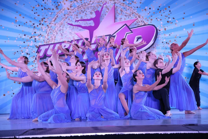 HSD company dancers celebrating together on stage