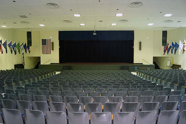 View across the auditorium seating toward the stage at Highland High School